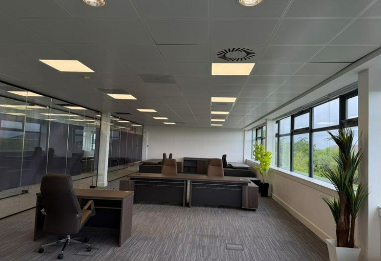 Spacious office workspace with dark wood desks and natural light from large windows at Hermiston Quay, 5, Cultins Road.