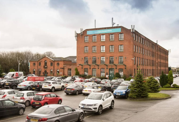 Hollinwood Business Centre exterior view showing the red brick building and car park.