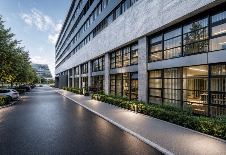 Exterior view of the modern glass and stone facade at Landis + Gyr-Strasse 1.