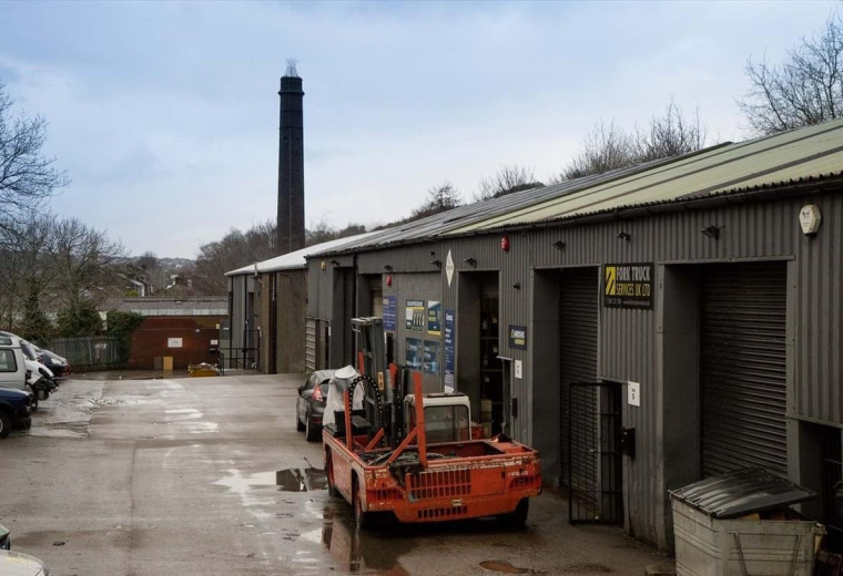 Exterior view of the industrial units and brick chimney at Linthwaite Business Centre.