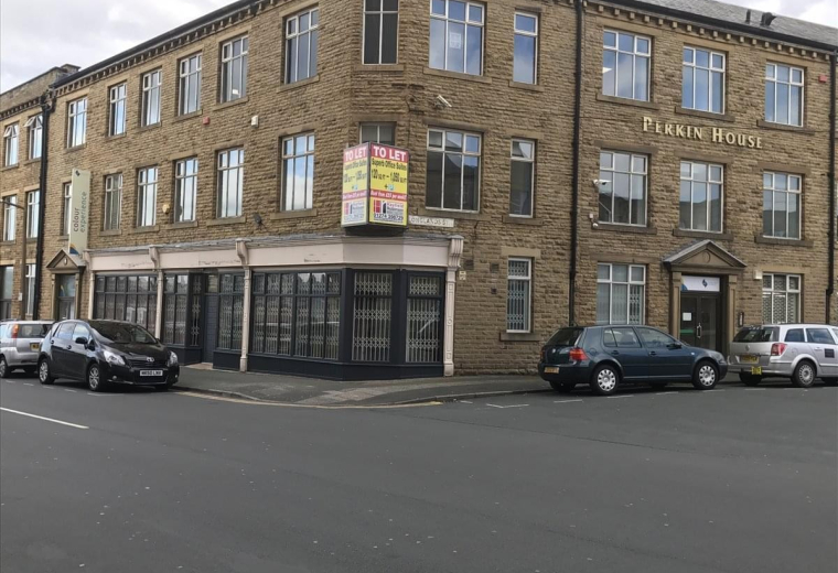 Exterior view of the traditional stone-built Longlands Street building in Bradford.