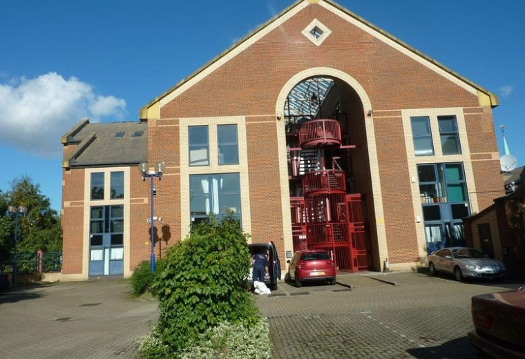 The brick facade and arched entrance of St Olav’s Court, 25 Lower Road.