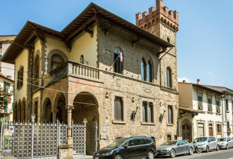 Exterior view of the historic stone building facade of Via Guglielmo Marconi.