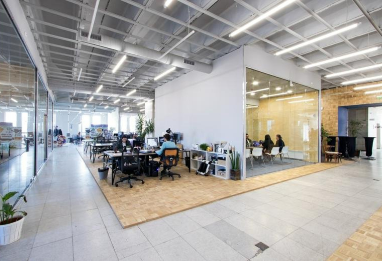 Spacious interior of the Sofia Center, Shipka Street 6 office with open-plan desks and glass meeting rooms.