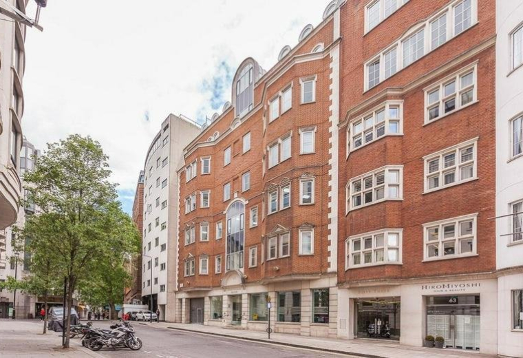Exterior view of Nightingale House at 65 Curzon St with red brick facade and large bay windows.