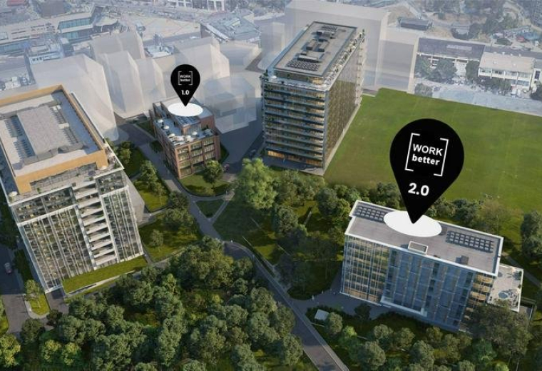 Aerial view of the building complex showing three modern structures and green spaces.