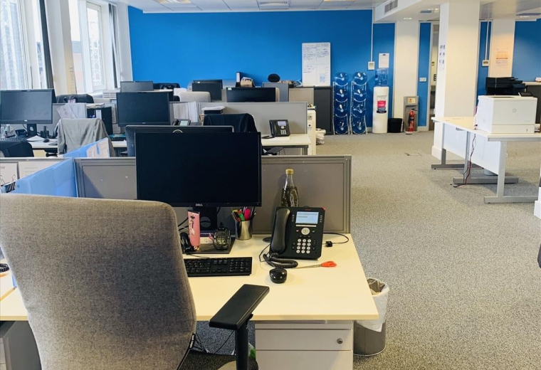 Spacious open-plan office at St Clare House, 30-33 Minories, showing multiple desks and blue partitions.