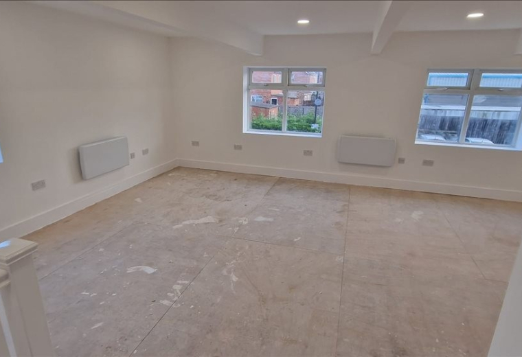 Spacious open-plan office at 11 West View with neutral walls and multiple windows for natural light.