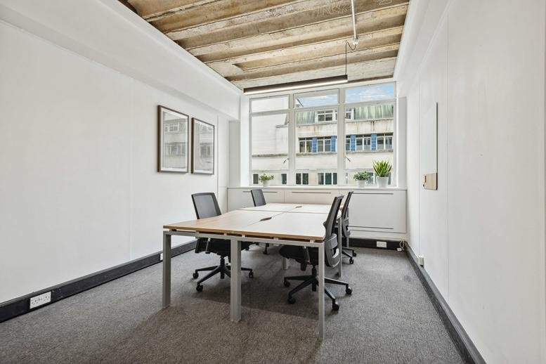 A private four-person office at Britannia House with exposed timber ceilings and natural light.
