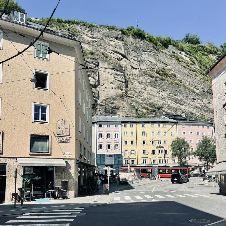 Exterior view of the historic building at 1, Münzgasse,Top 36 / 37 set against a steep rock face.