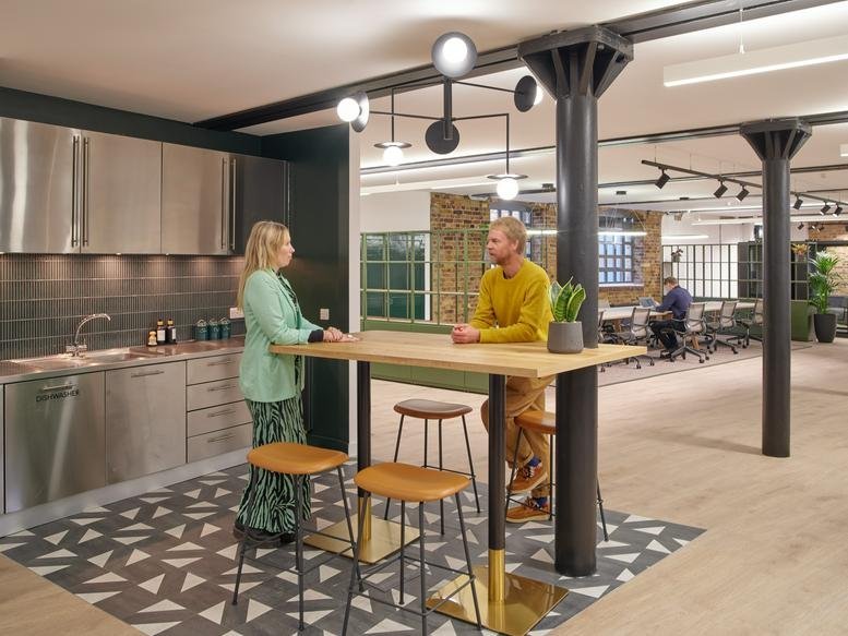 Breakout kitchen and bar area with high stools and modern lighting at 1 Valentine Place.