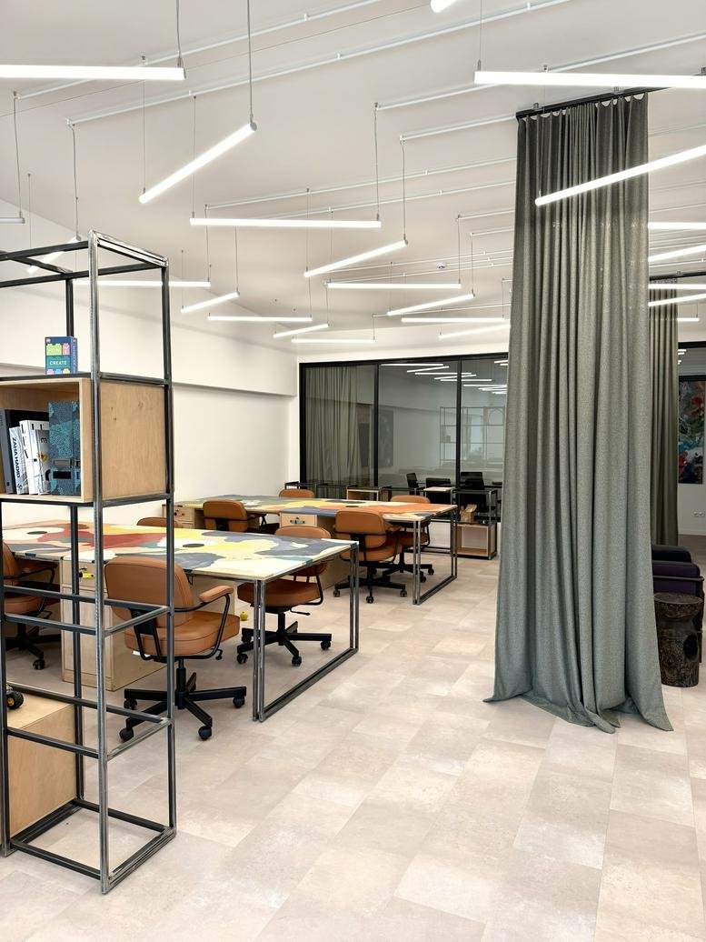 Spacious open-plan workspace at 101A, Raudondvario plentas with artistic desks and linear lighting.