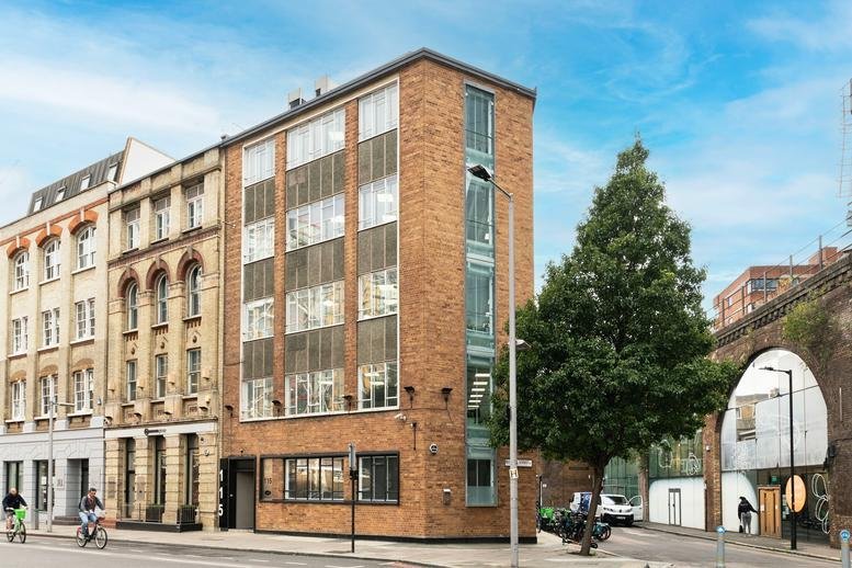 Exterior view of the brick facade at 115, Southwark Street near a modern railway arch.