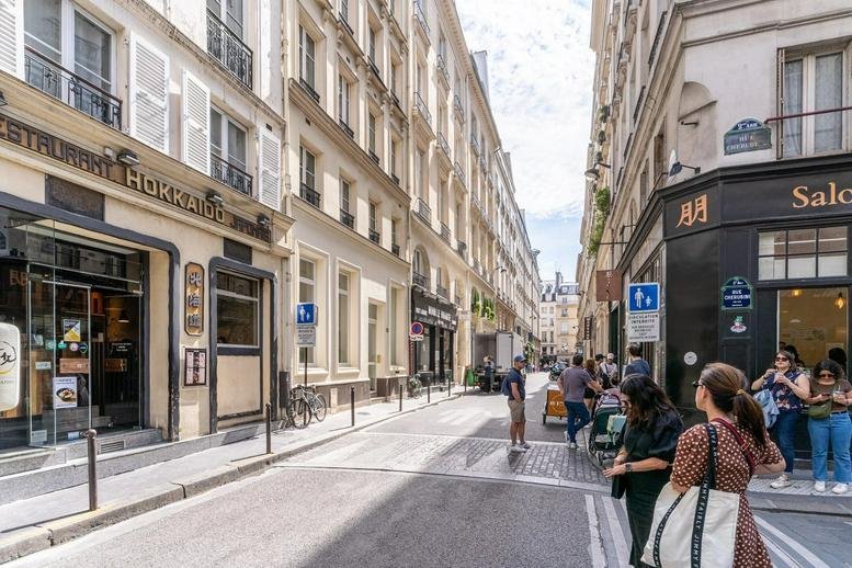 Exterior street view of the traditional stone building facade at 12, Rue Chabanais.