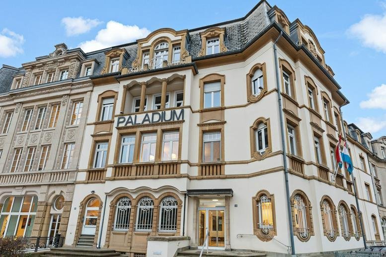 Exterior view of the ornate Palladium building featuring classical architecture and stone carvings.