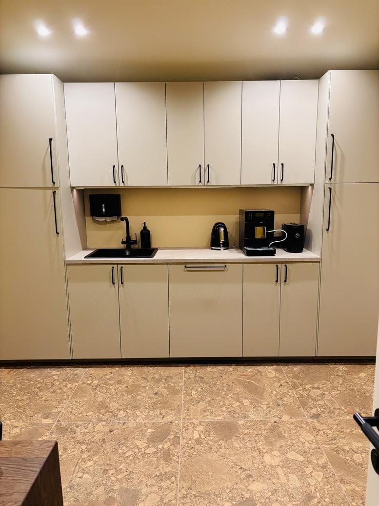 Wide-angle view of a modern kitchen at 130K9, Krišjāņa Barona iela with minimalist white cabinetry.