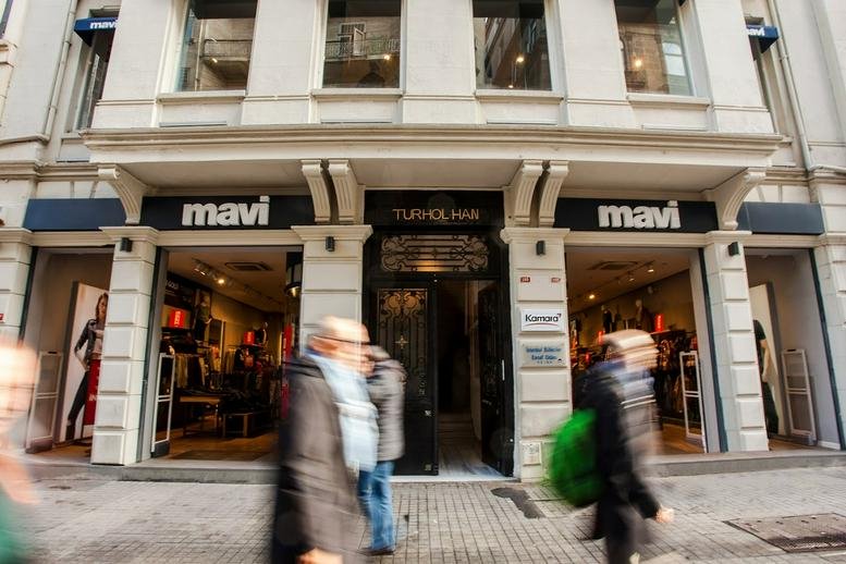 Exterior view of the Turhol Han building entrance at 189 İstiklal Caddesi with Mavi retail storefronts.
