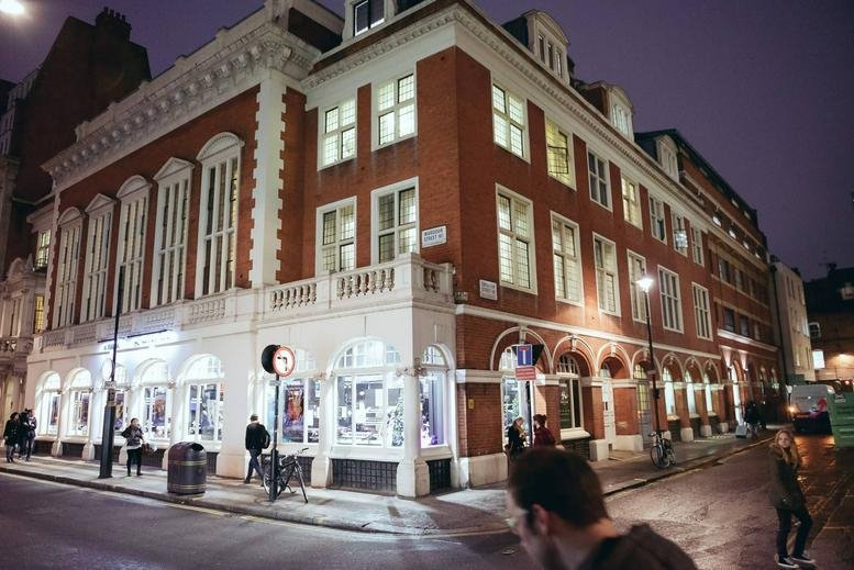 Exterior night view of the brick facade at 2 Sheraton Street, London, London Central.