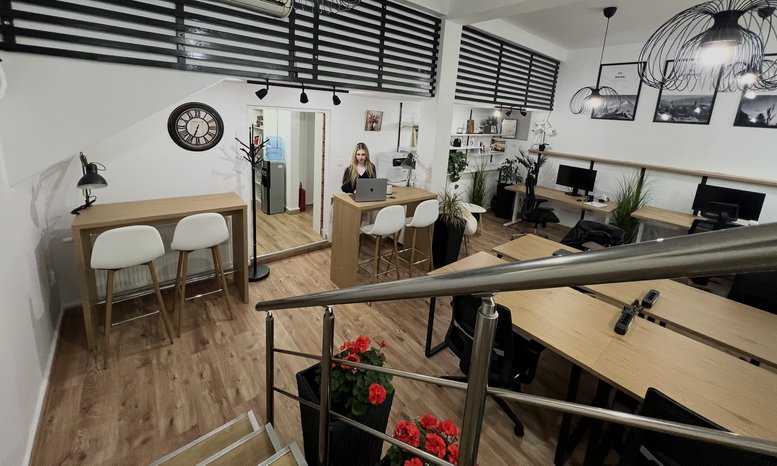 Wide view of a modern coworking space at 20, улица Хан Аспарух with wooden desks and stairs.