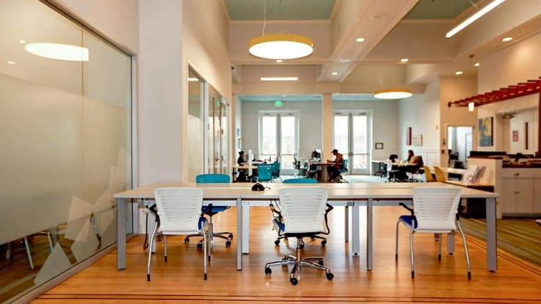 Bright, modern coworking space at 229-231 High Holborn, Floors 1 - 6 with shared desks and round pendant lighting.