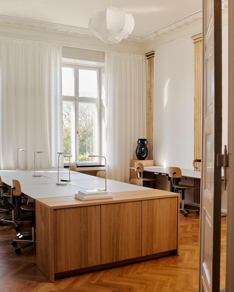 Spacious co-working office at 26, Kronprinsessegade, with wooden cabinetry and ample natural light.