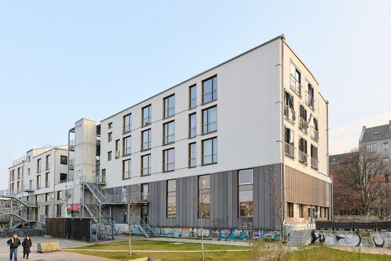 Exterior view of the modern white and grey multi-storey building at 28A, Rollbergstraße.