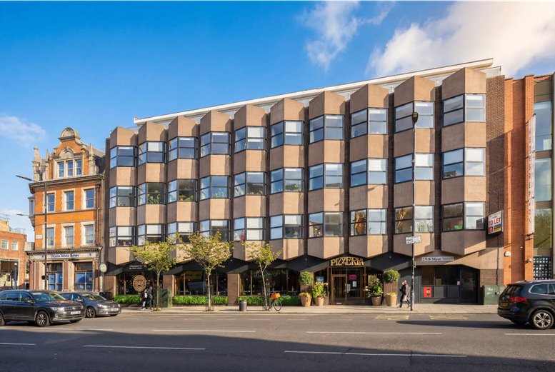 Exterior view of the brick building at 290, Mare Street featuring distinct bay windows and ground floor shops.