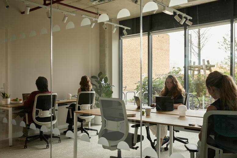 Spacious coworking area with individual desks and large windows at 3, Watermead Way.