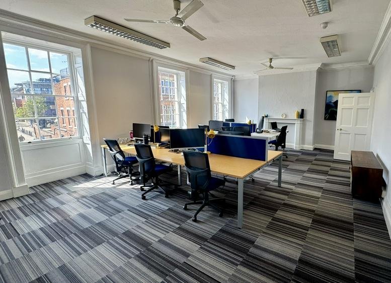Spacious open-plan workspace at 30, Foregate Street, featuring multiple desks, ergonomic chairs, and large windows.