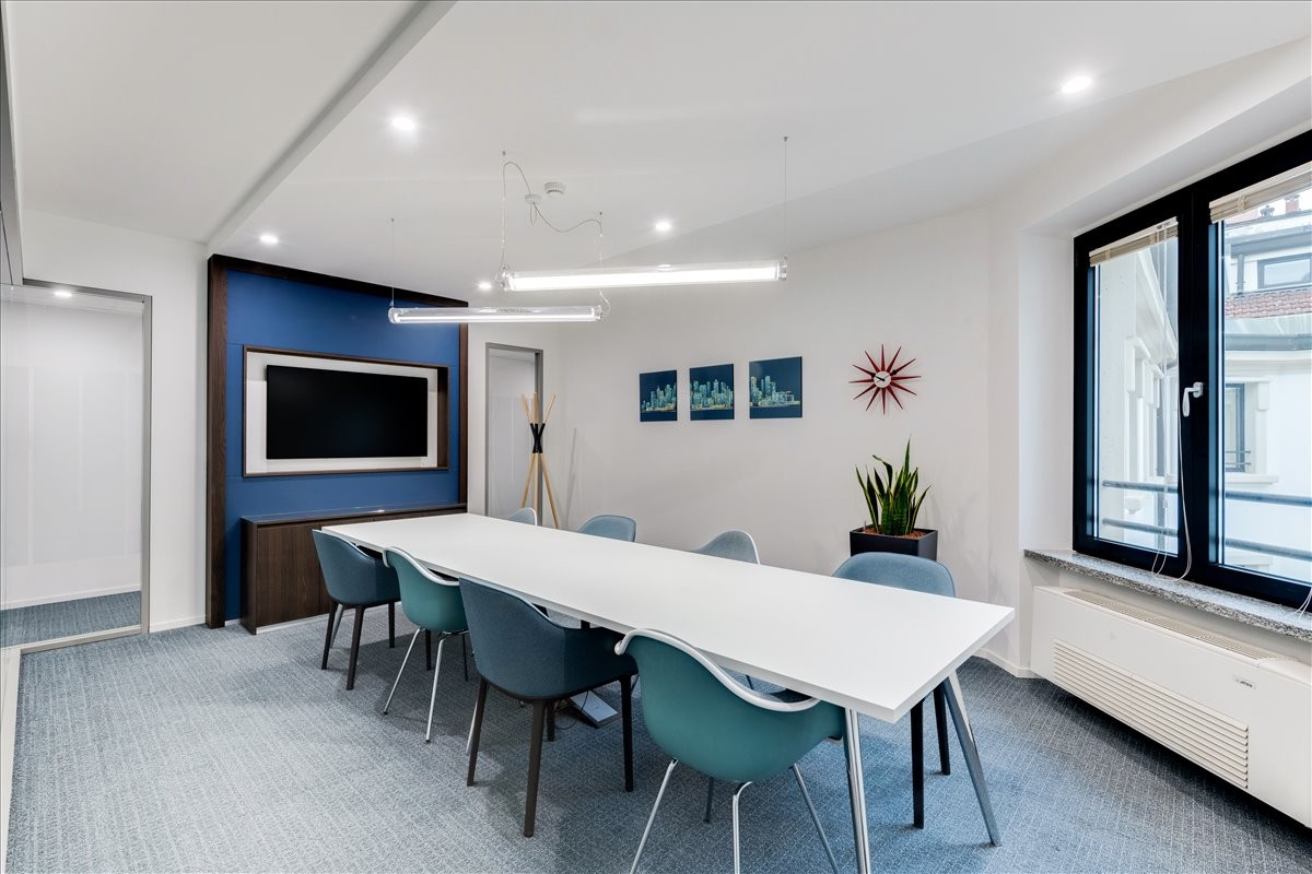 A professional meeting room at 31 North Street, Swords, Co. Dublin with a blue accent wall and large white table.