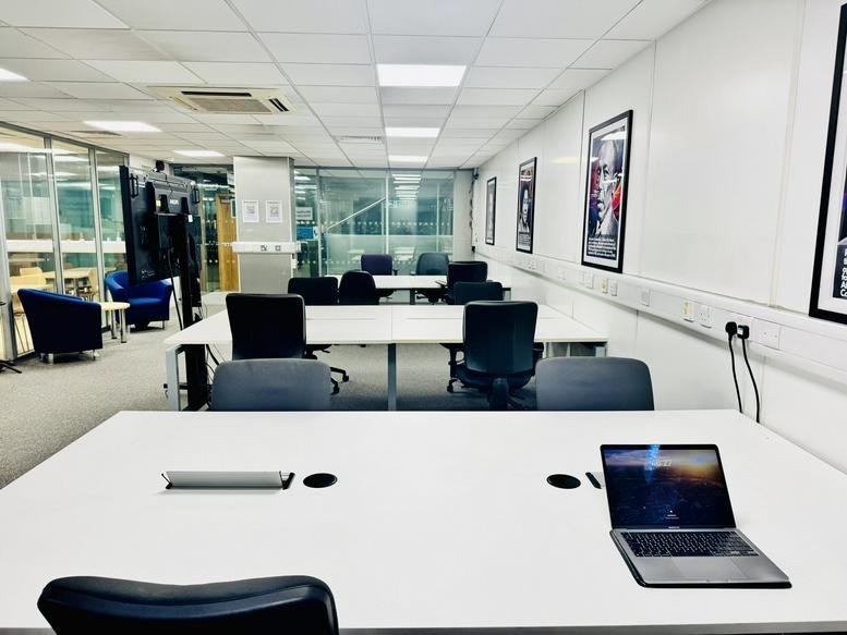 Spacious open-plan office with white desks and black ergonomic chairs at 32-38, Theobalds Road.