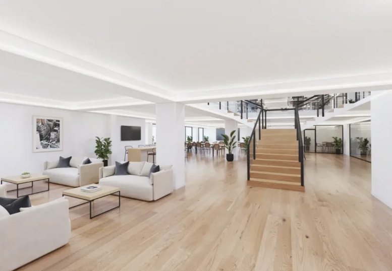 Spacious communal lounge with white sofas and wooden floors at 34, Avenue des Champs-Élysées.