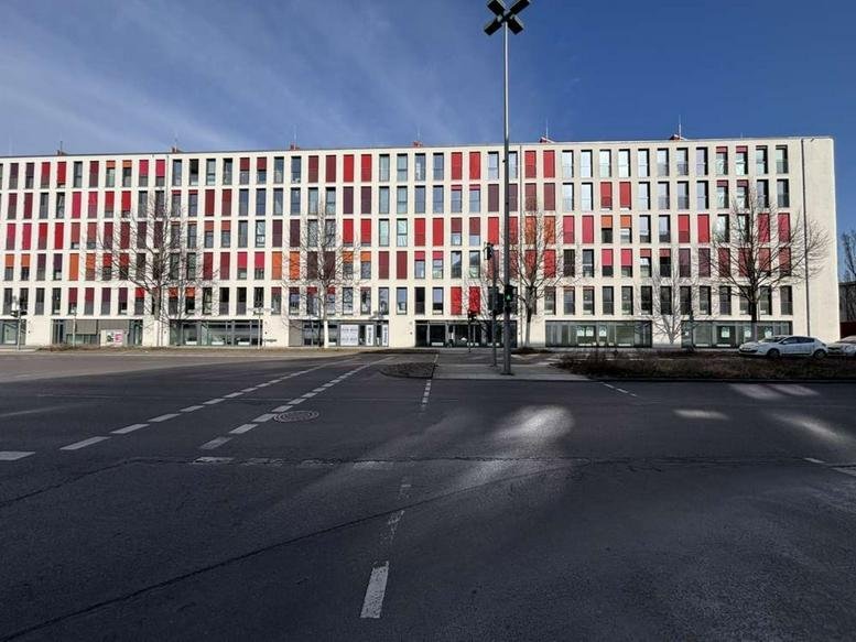 Exterior view of the modern white and red facade at 34B, Rudower Chaussee.