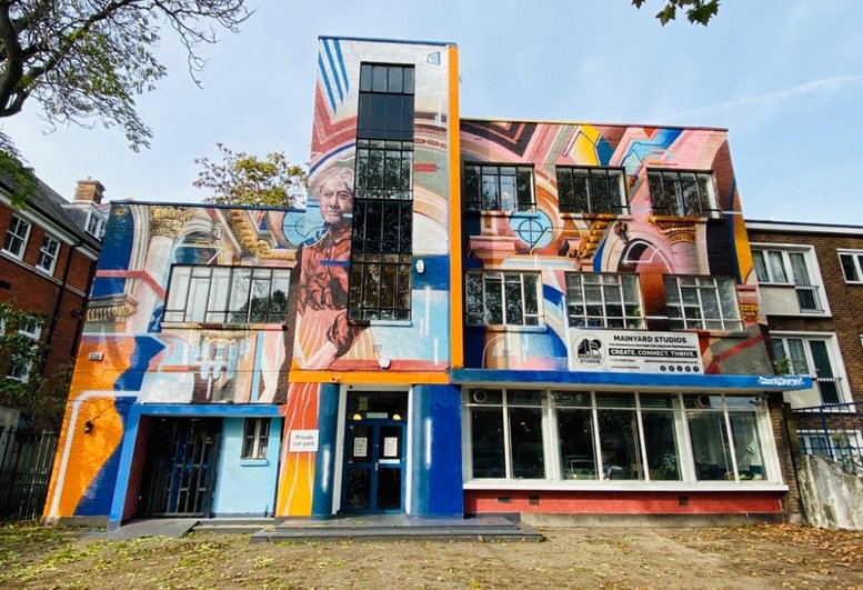 Exterior view of the colorful mural-covered building facade at 35, Bow Road.