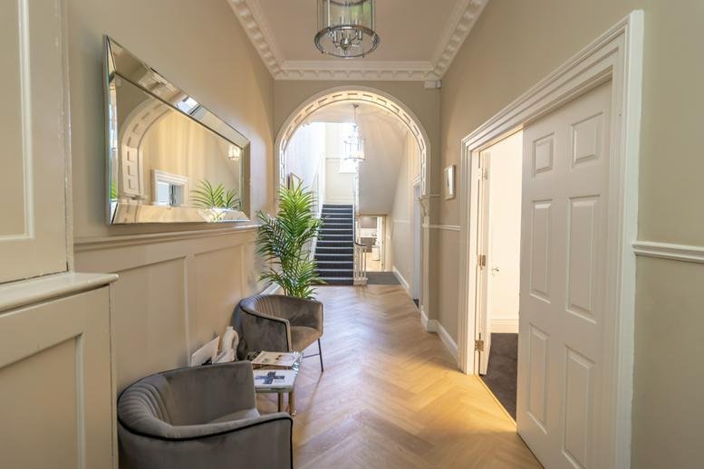 Grand hallway entrance at 37, Baggot Street Lower, featuring arched doorway and herringbone wood floors.