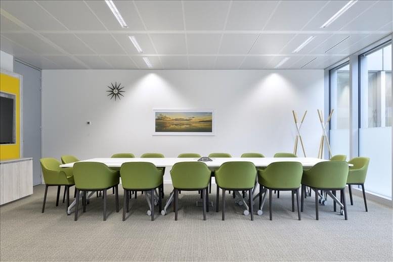 Meeting room at 39 Eign Gate with a large white table and green upholstered chairs.
