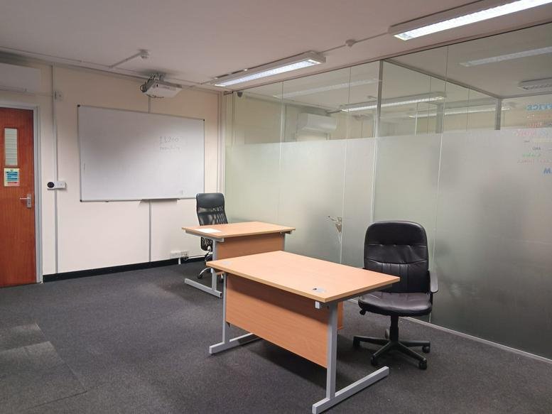 Spacious private office at Forest House with two desks and a whiteboard.