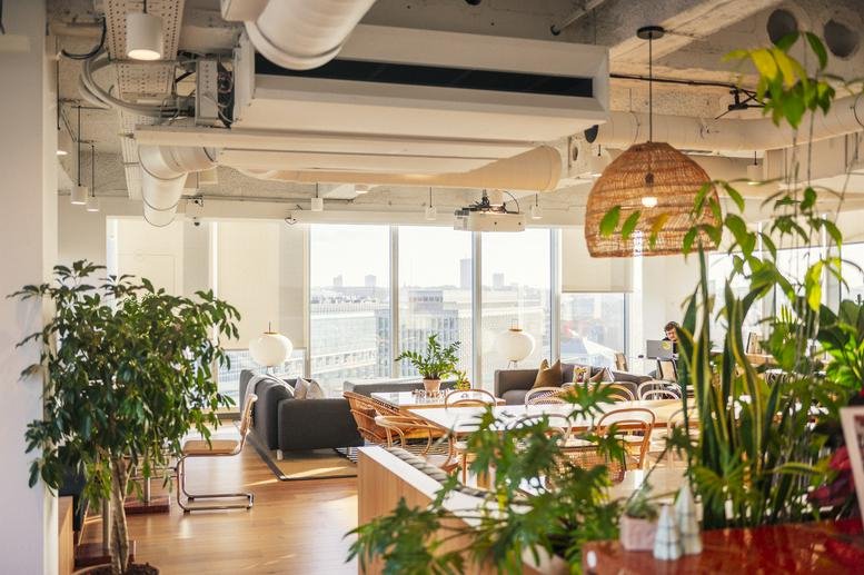 Bright common area at 4, Boulevard Saint-Lazare, Botanic Tower featuring plants and city views.