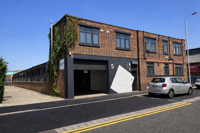 Industrial brick exterior of 5, Argall Avenue featuring a unique geometric mural.