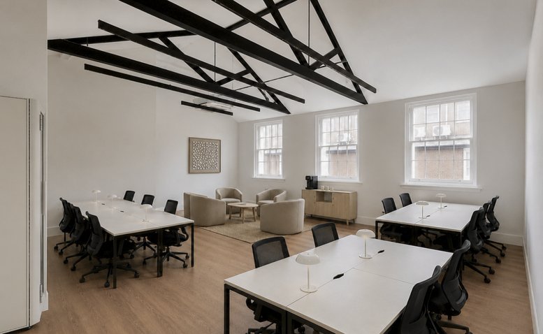 Spacious office workspace with dark timber ceiling beams and white desks at 5, Grosvenor Gardens.