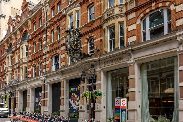 Ornate brick exterior facade of the building at 5, Southampton Street featuring a prominent hanging clock.