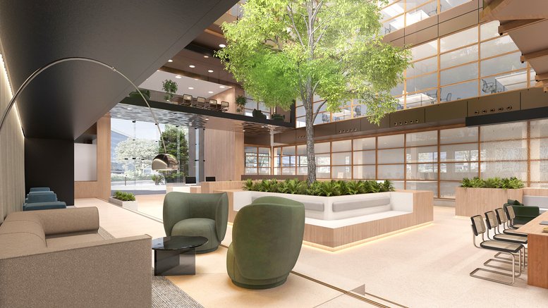 Grand multi-level atrium at 58, Clarendon Road featuring a central tree and modern lounge seating.
