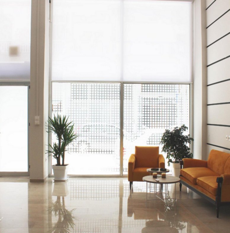 Lobby and reception area at 59, Analipseos, featuring high ceilings and floor-to-ceiling windows.