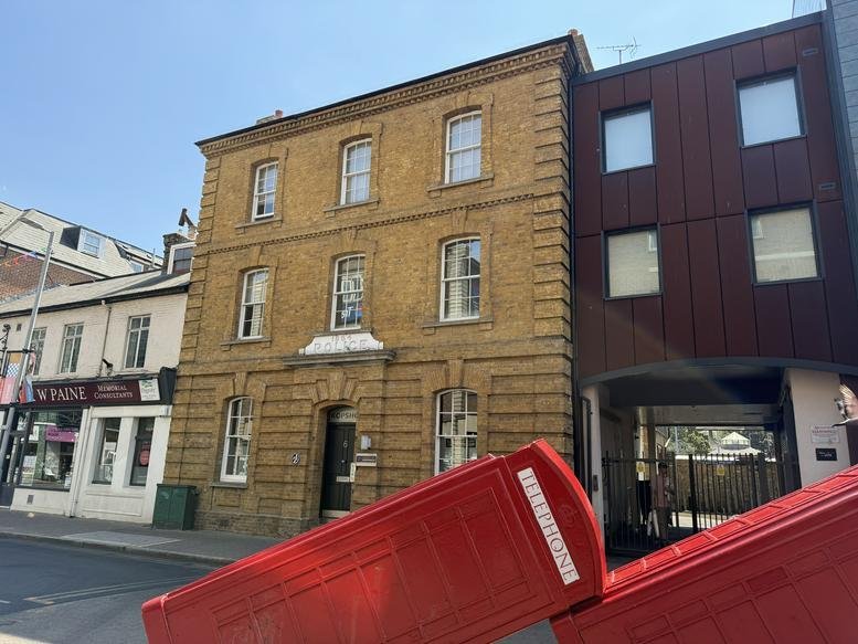 Exterior view of the historic brick building at 6, Old London Road with a modern wooden extension.