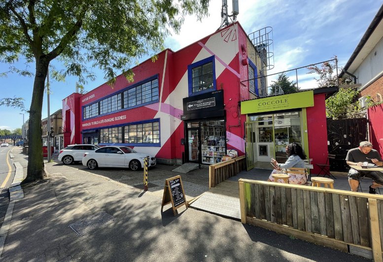 Exterior view of the colorful red and white building facade at 679, High Road Leyton.