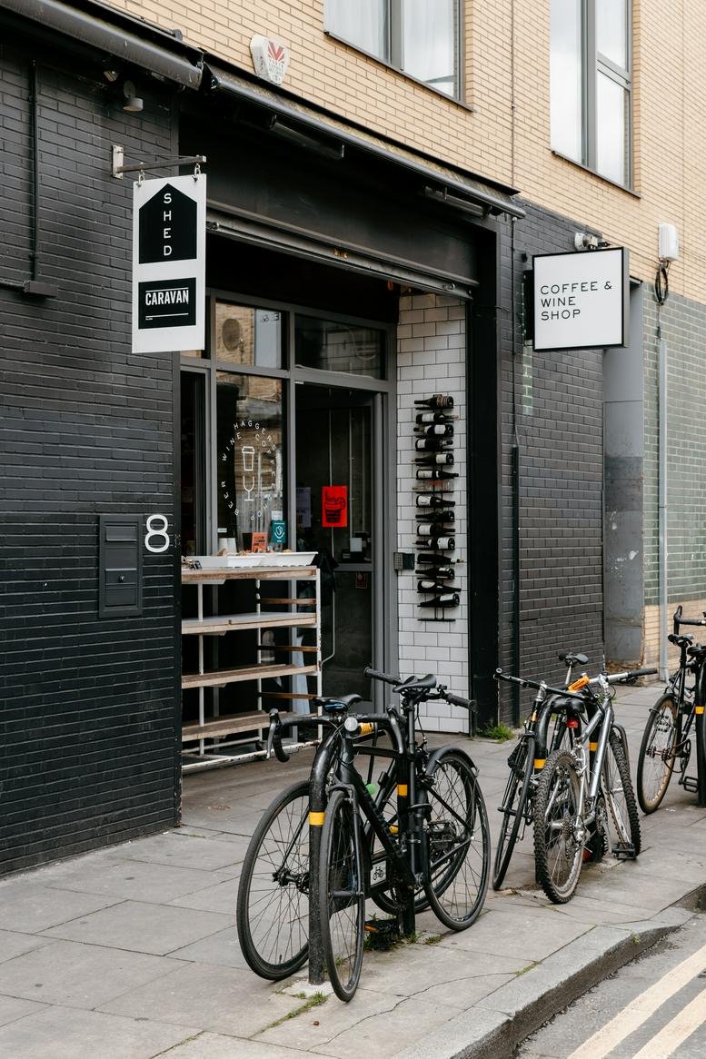 Entrance of 8, Lee Street featuring a black brick facade and bicycles parked out front.