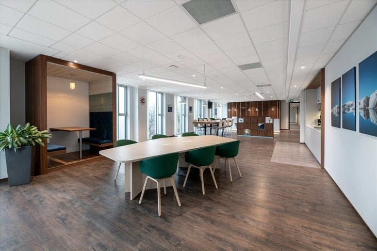 Spacious communal area with a long table and stylish lighting
