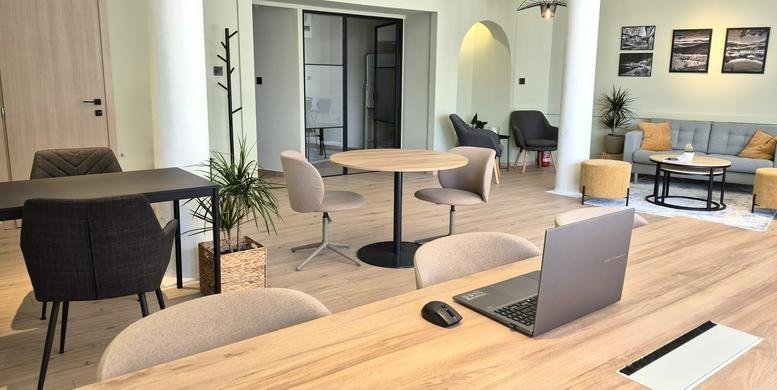 Spacious coworking area at 97, Mitropoleos with modern wood desks and natural light.