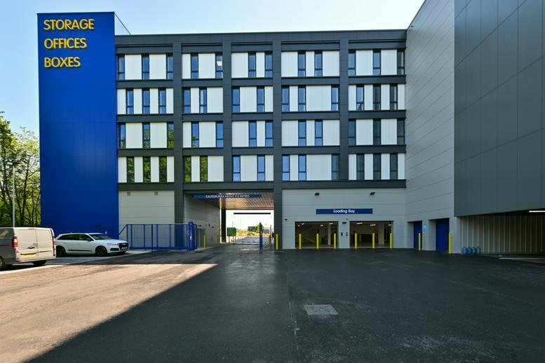 Exterior view of the modern Access Business Centre building with prominent blue and yellow branding.