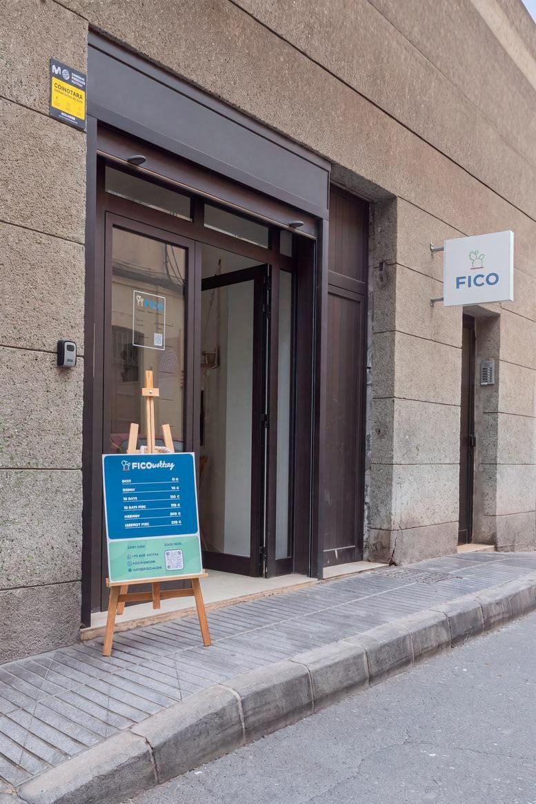 Entrance of the Calle Prudencio Morales,73 office building with a branded sign on a stone facade.